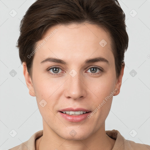 Joyful white young-adult female with short  brown hair and grey eyes