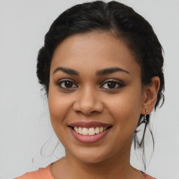 Joyful latino young-adult female with long  brown hair and brown eyes