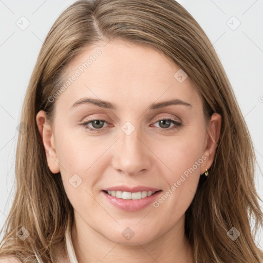 Joyful white young-adult female with long  brown hair and blue eyes