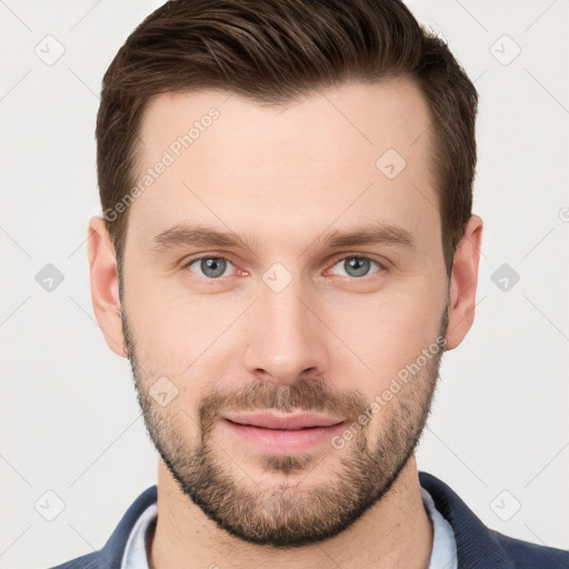 Joyful white young-adult male with short  brown hair and grey eyes