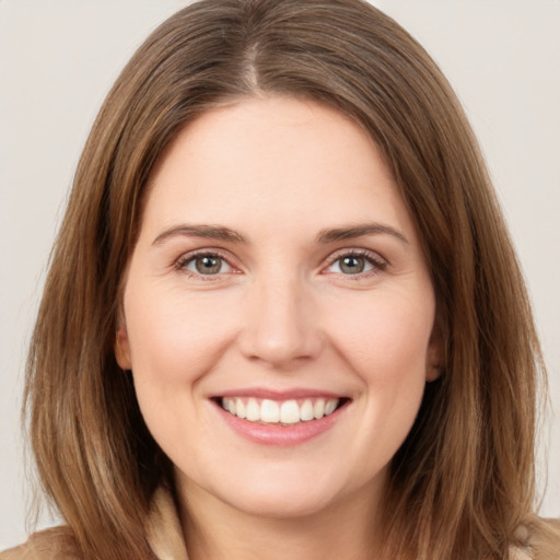 Joyful white young-adult female with medium  brown hair and green eyes