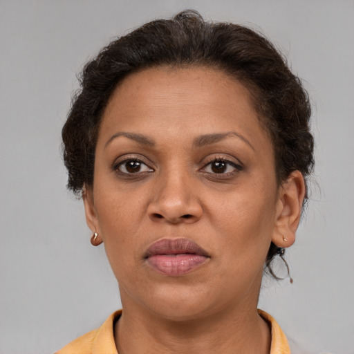 Joyful latino adult female with short  brown hair and brown eyes