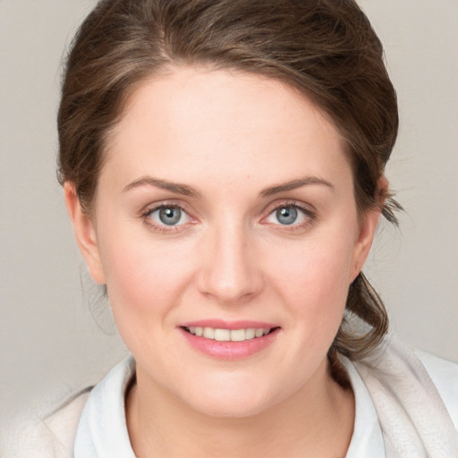 Joyful white young-adult female with medium  brown hair and blue eyes