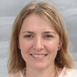 Joyful white young-adult female with medium  brown hair and blue eyes