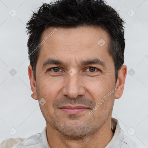 Joyful white adult male with short  brown hair and brown eyes