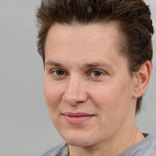 Joyful white adult male with short  brown hair and grey eyes