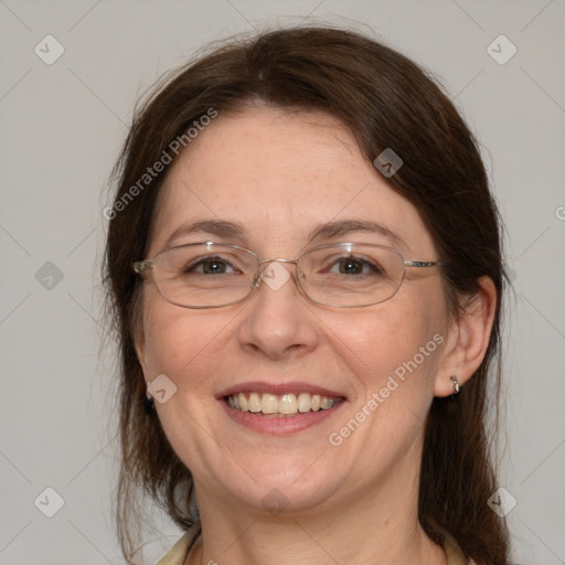 Joyful white adult female with medium  brown hair and grey eyes