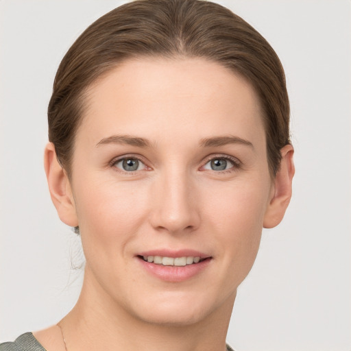 Joyful white young-adult female with short  brown hair and grey eyes