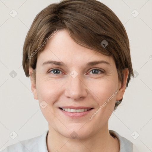 Joyful white young-adult female with short  brown hair and grey eyes