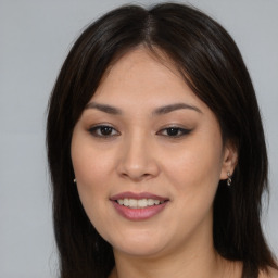 Joyful asian young-adult female with long  brown hair and brown eyes