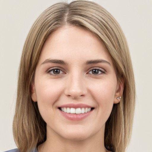 Joyful white young-adult female with medium  brown hair and grey eyes