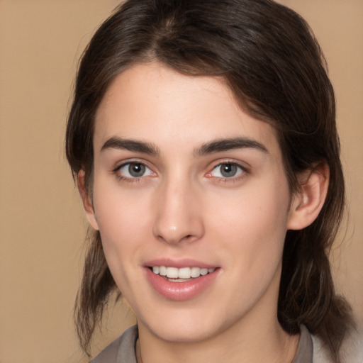 Joyful white young-adult female with medium  brown hair and brown eyes