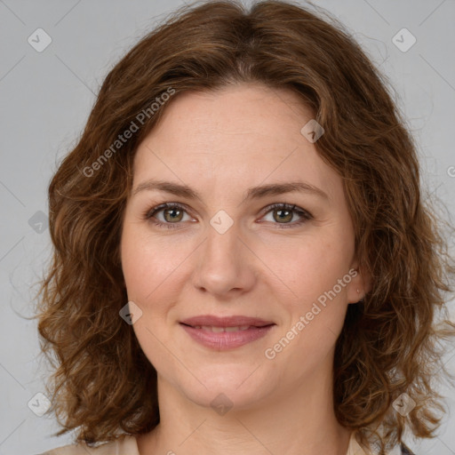 Joyful white young-adult female with medium  brown hair and green eyes