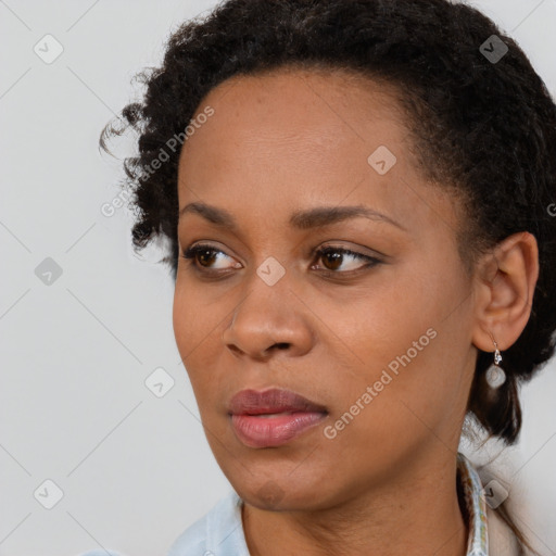 Joyful black young-adult female with short  brown hair and brown eyes