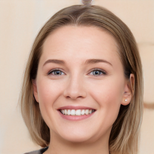 Joyful white young-adult female with long  brown hair and blue eyes