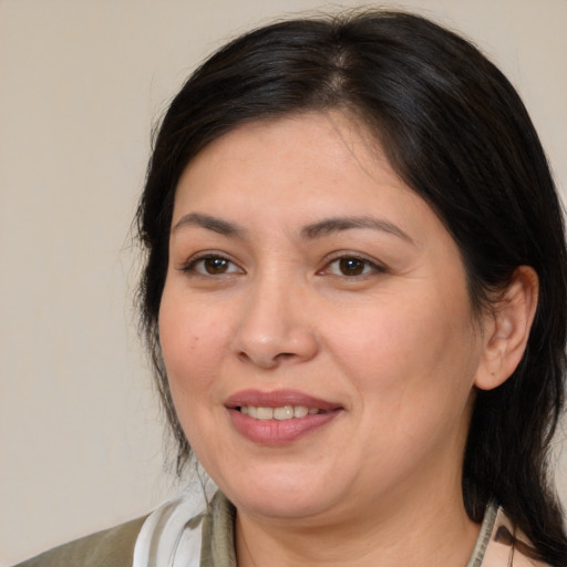 Joyful white adult female with medium  brown hair and brown eyes