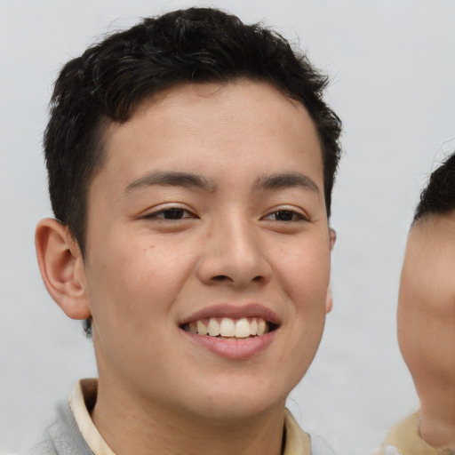 Joyful asian young-adult male with short  brown hair and brown eyes