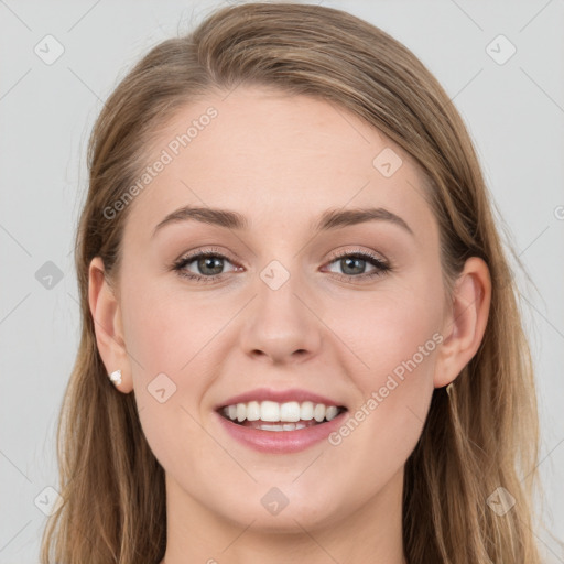 Joyful white young-adult female with long  brown hair and blue eyes