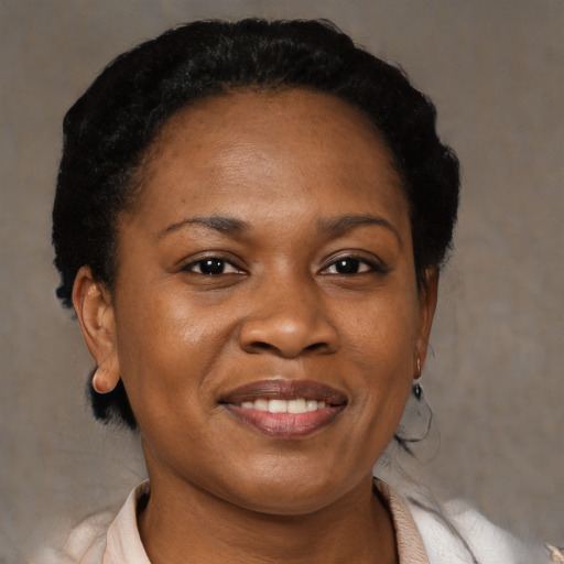 Joyful black adult female with short  black hair and brown eyes