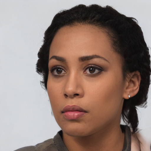 Neutral latino young-adult female with long  black hair and brown eyes