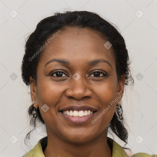 Joyful black adult female with medium  brown hair and brown eyes