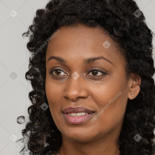 Joyful black young-adult female with long  brown hair and brown eyes