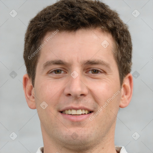 Joyful white young-adult male with short  brown hair and grey eyes