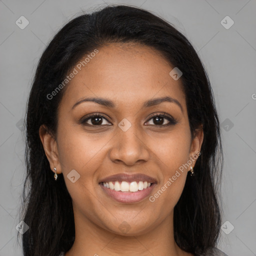 Joyful black young-adult female with long  brown hair and brown eyes