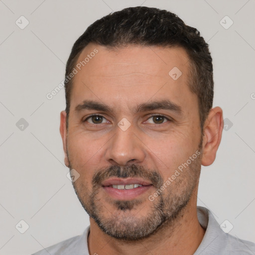 Joyful white adult male with short  black hair and brown eyes