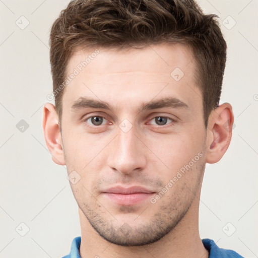 Neutral white young-adult male with short  brown hair and grey eyes