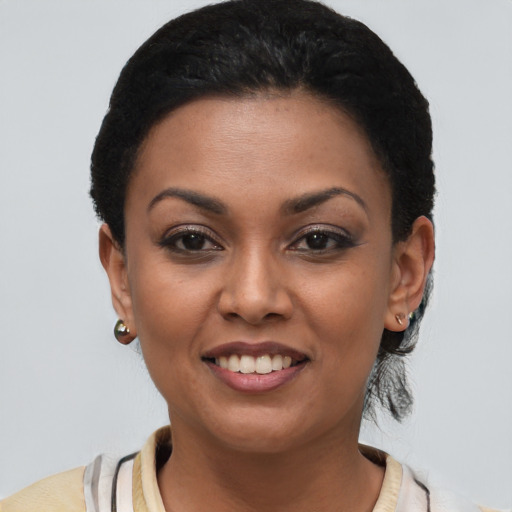 Joyful latino young-adult female with short  brown hair and brown eyes