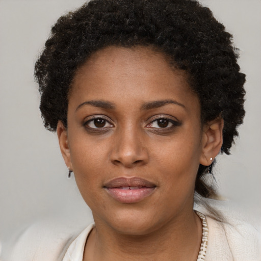 Joyful black young-adult female with short  brown hair and brown eyes