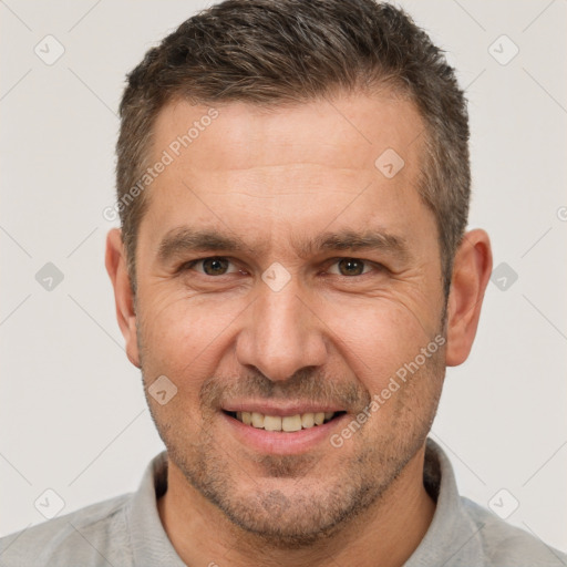 Joyful white adult male with short  brown hair and brown eyes