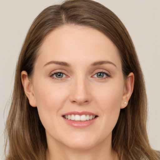 Joyful white young-adult female with long  brown hair and grey eyes