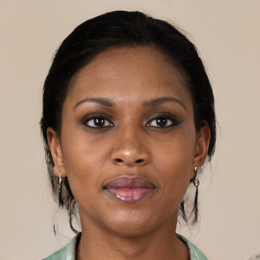 Joyful black young-adult female with medium  brown hair and brown eyes