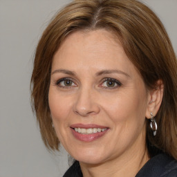 Joyful white adult female with medium  brown hair and brown eyes