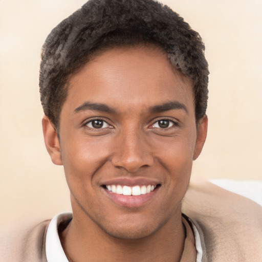 Joyful black young-adult male with short  brown hair and brown eyes