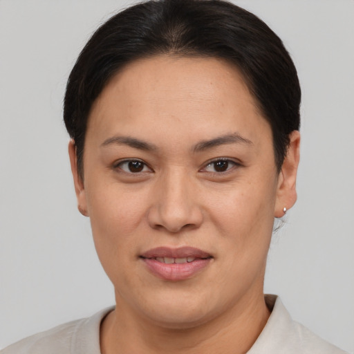 Joyful asian adult female with short  brown hair and brown eyes