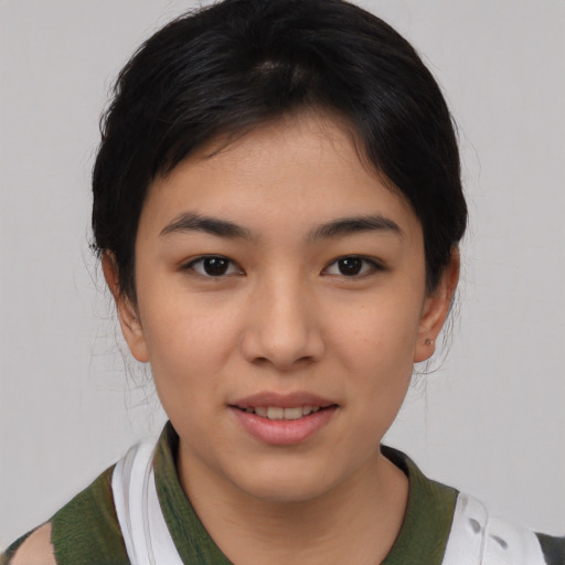 Joyful asian young-adult female with short  black hair and brown eyes