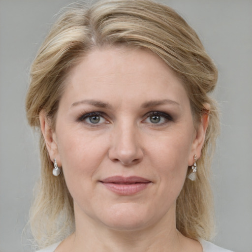 Joyful white adult female with medium  brown hair and grey eyes