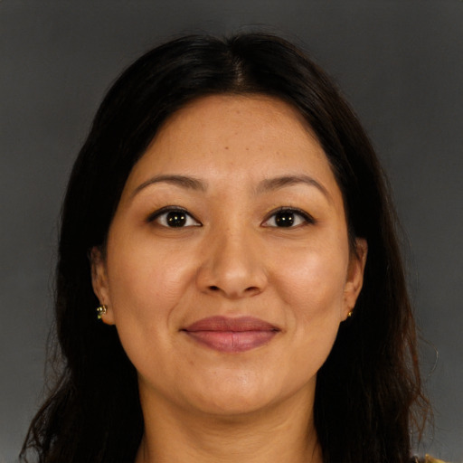 Joyful latino adult female with long  brown hair and brown eyes