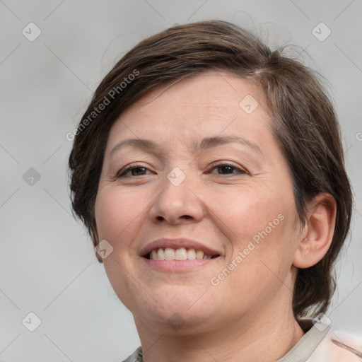 Joyful white adult female with medium  brown hair and brown eyes