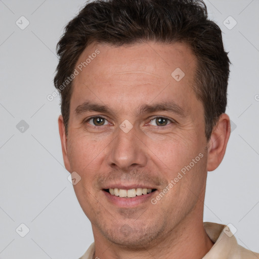 Joyful white adult male with short  brown hair and brown eyes