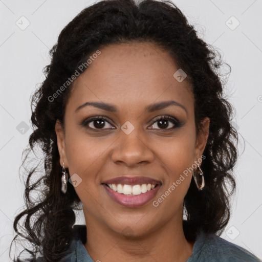 Joyful black young-adult female with long  brown hair and brown eyes