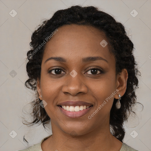 Joyful black young-adult female with medium  brown hair and brown eyes