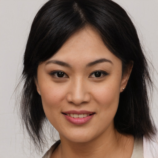 Joyful asian young-adult female with medium  brown hair and brown eyes