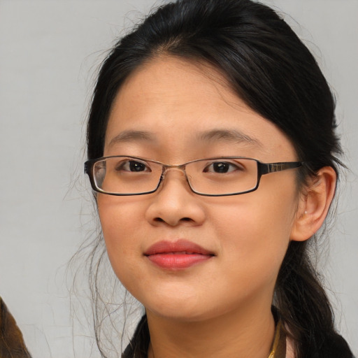 Joyful asian young-adult female with medium  brown hair and brown eyes