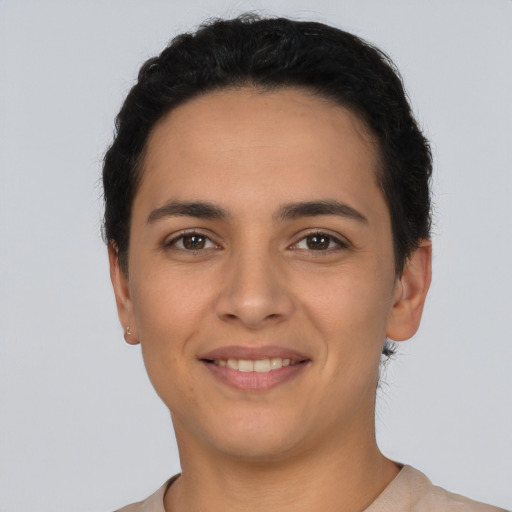 Joyful latino young-adult female with short  black hair and brown eyes