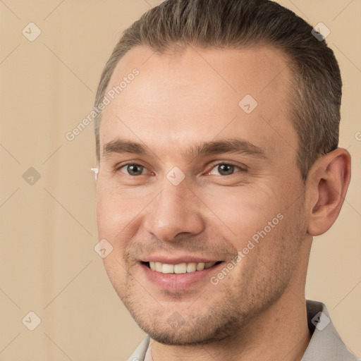 Joyful white young-adult male with short  brown hair and brown eyes