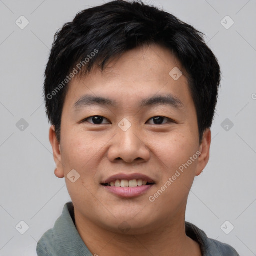 Joyful asian young-adult male with short  brown hair and brown eyes